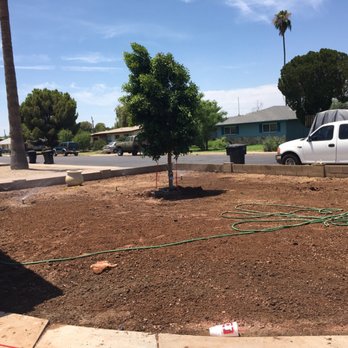 The 4 Landscapers - a man working on a garden - Landscaping Near Me