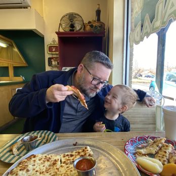 Chaney's Pizza - a man and a child eating pizza - Pizza Near Me - Eufaula, Oklahoma Chaney's Pizza - a man and a child eating pizza - Pizza Near Me - Eufaula, Oklahoma