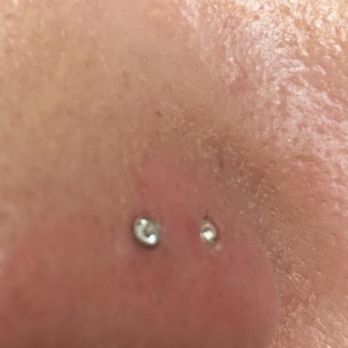 12th Avenue Tattoo - L-shaped piercing sinking into nostril due to slight swelling - Tattoo Near Me - Nampa, Idaho 12th Avenue Tattoo - L-shaped piercing sinking into nostril due to slight swelling - Tattoo Near Me - Nampa, Idaho