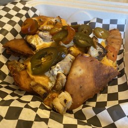 Naanchos with yogurt-marinated chicken to go.