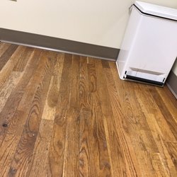 Rhode Island Health Group - All sorts of stuff on the floor and dirty garbage can in room?? This can't be a health care place??