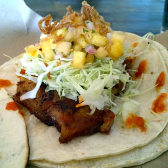 Tacofino Commissary - Pork jowl taco with cabbage, fried shallot, pineapple, and sriracha on corn tortillas - Mexican Near Me - Vancouver, British Columbia Tacofino Commissary - Pork jowl taco with cabbage, fried shallot, pineapple, and sriracha on corn tortillas - Mexican Near Me - Vancouver, British Columbia
