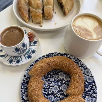 Hasel Cafe - Borek with Ground Beef $9.99 (top), Simit $3.99 (bottom), golden tumeric latte &6.50(?) (right), Turkish coffee $3.99 (left) - Coffee & Tea Near Me - Renton, Washington