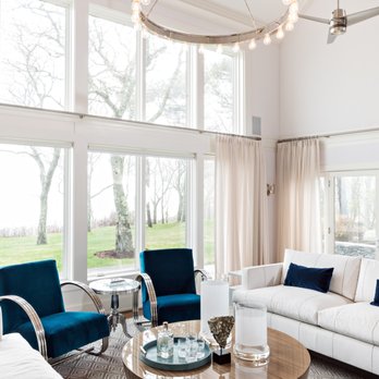 International Builders - a living room with a large chandelier - General Contractors Near Me - Boston, Massachusetts International Builders - a living room with a large chandelier - General Contractors Near Me - Boston, Massachusetts