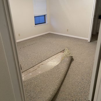 D&D Remodeling & Flooring Services - an empty room with a surfboard on the floor - Flooring Near Me D&D Remodeling & Flooring Services - an empty room with a surfboard on the floor - Flooring Near Me