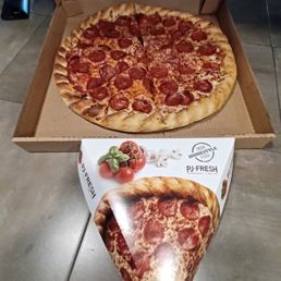 Pizza in single slice box and a large pepperoni pizza.