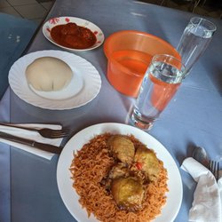 Mama's African Grill-Bar - The fish stew, the handwash basin, the fufu, and the jollof rice