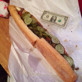 Leo's Steak Shop - You see what I'm saying? If you order a Leo's Large cheesesteaks, you might as well be sharing. ( dollar bill is for scale size) - Sandwiches Near Me - Folcroft, Pennsylvania