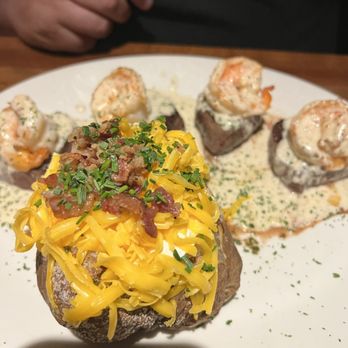 Stoney River - Whiskey shrimp filet medallions with loaded baked potato - Steakhouses Near Me - Franklin, Tennessee
