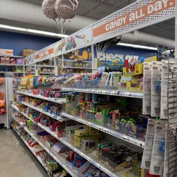 Five Below - Shelves stocked with various candies and toys are visible in a Five Below store, with birthday balloons hanging overhead. - Discount Store Near Me - Mayfield Heights, Ohio