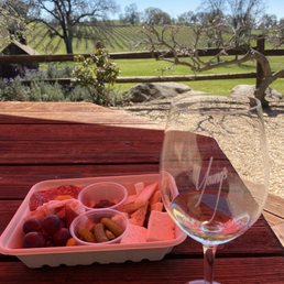 a glass of wine and a tray of fruit a glass of wine and a tray of fruit