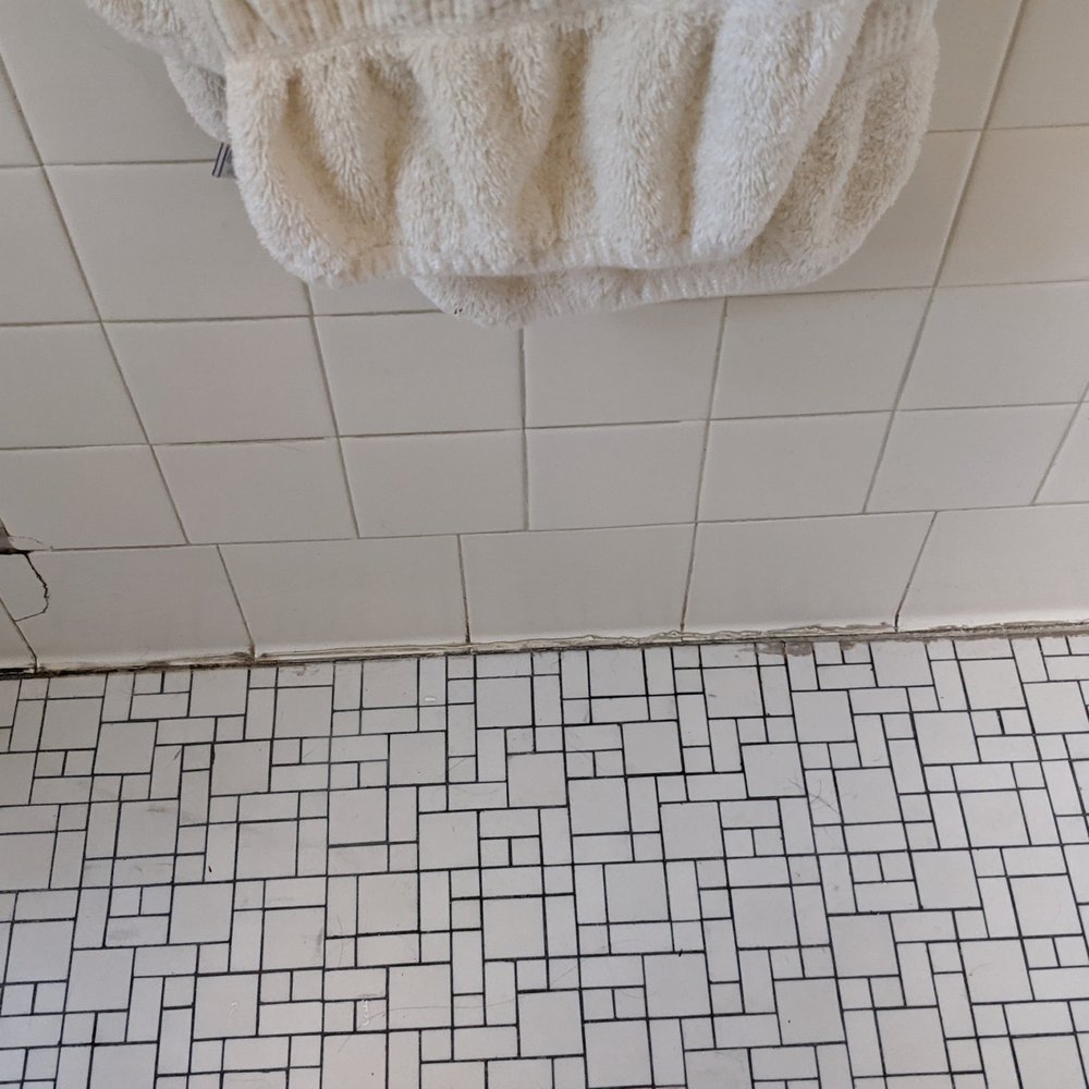 The Tile Solution - Shower: Before photo 1: Our bathroom from 1935 had ugly repairs, cracks and missing grout. - Flooring Near Me - Mount Kisco, New York The Tile Solution - Shower: Before photo 1: Our bathroom from 1935 had ugly repairs, cracks and missing grout. - Flooring Near Me - Mount Kisco, New York