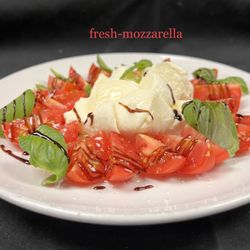 Vicini's Restaurant and Pizza - Mozzarella Caprese made with homemade mozzarella, balsamic glaze and fresh basil