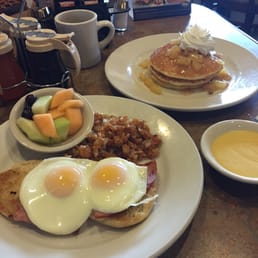Eggs Benedict with hollandaise on the side and apple pie pancakes Eggs Benedict with hollandaise on the side and apple pie pancakes
