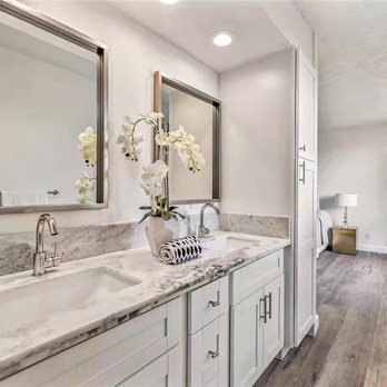 J Construction - a bathroom with two sinks and a large mirror - General Contractors Near Me J Construction - a bathroom with two sinks and a large mirror - General Contractors Near Me