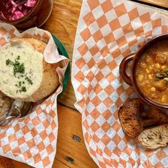 Panacea - Classic New England Clam Chowder in a sourdough bread bowl on the left and a smoky corn vegan chowder on the right * Maine Food * - Soup Near Me - Wiscasset, Maine