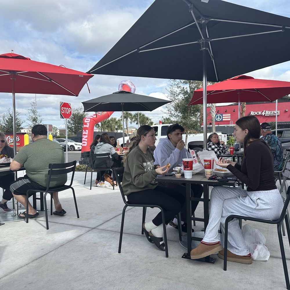 Raising Canes - Great outdoor dining tables - Fast Food Near Me - Lutz, Florida Raising Canes - Great outdoor dining tables - Fast Food Near Me - Lutz, Florida