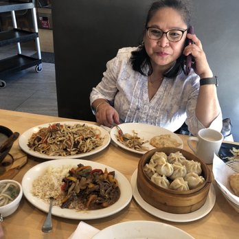 Mazalae Mongolian Restaurant - a woman talking on her cell phone - Mongolian Near Me - Morton Grove, Illinois