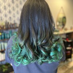 The Parlor Aveda - Emerald dreams with a bold twist. This rich brunette base with vibrant emerald green accents, created by Nikki