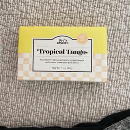 Seasonal flavor of orange and pineapple buttercream white chocolate rolled in coconut