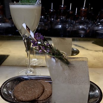 The Roosevelt Room - Milk Punch is the front drink out of a glass milk carton. - Cocktail Bars Near Me - Austin, Texas