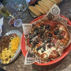 Bubba's Sports Bar - Individual Combination Pizza, Nacho Salad, garlic bread sticks.