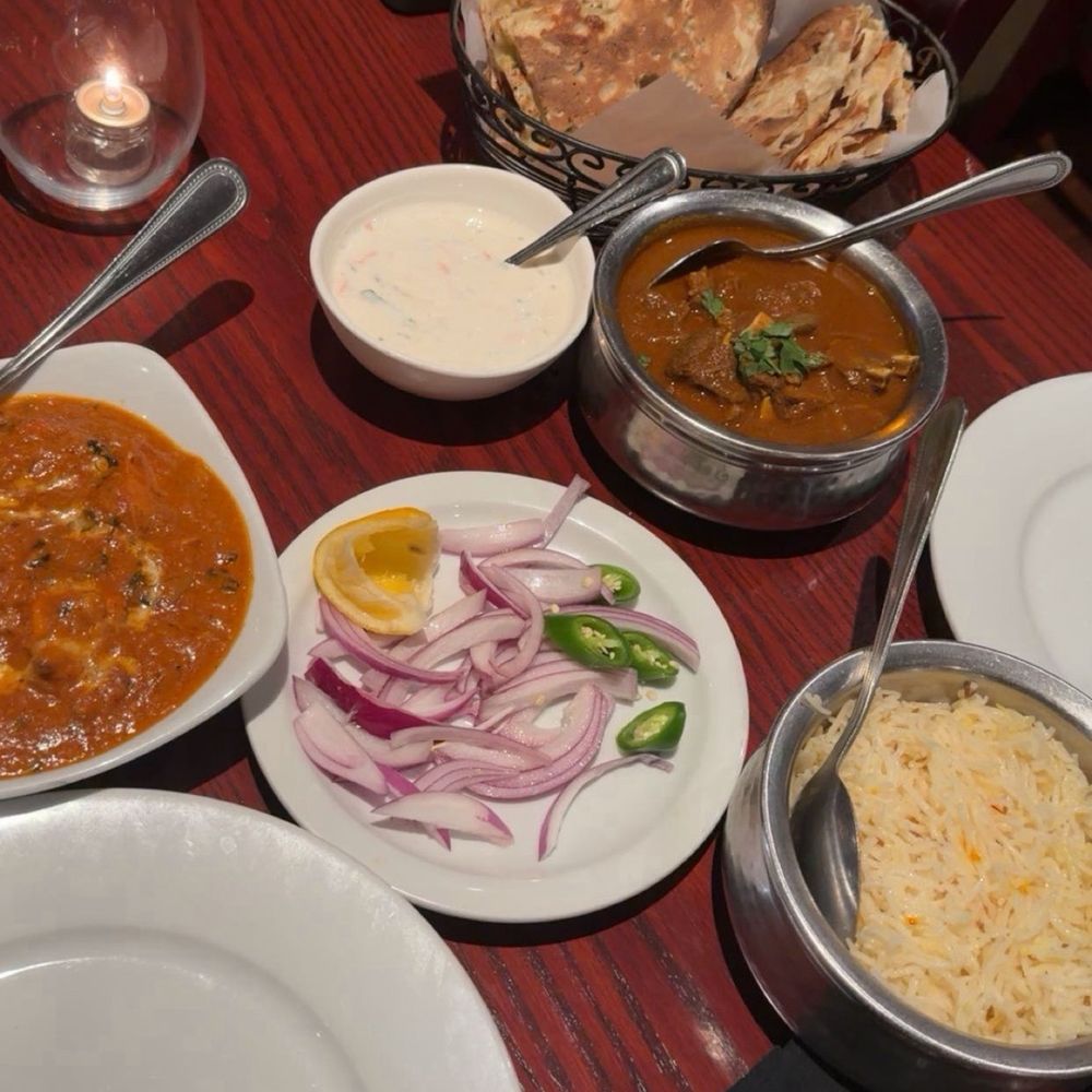 Chicken tikka masala, garlic and butter nann, rice and goat curry Chicken tikka masala, garlic and butter nann, rice and goat curry