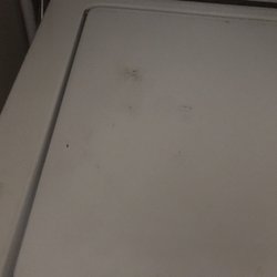 Hall Appliance - Dirt & grease; left by technicians, on washing machine cover.