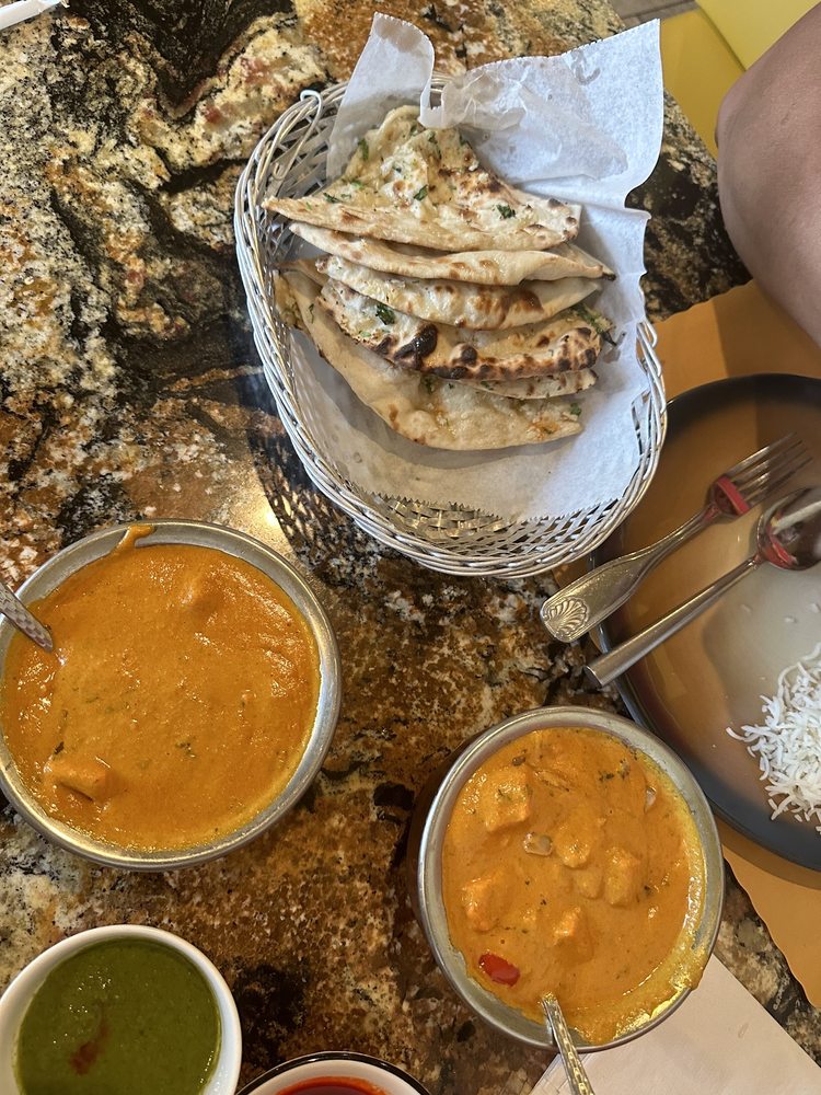 Butter Chicken left. Chicken Tikka Masala right. Garlic naan. Yelp