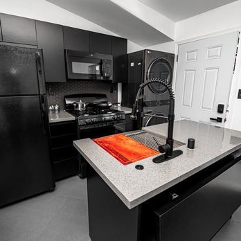 CA Restoration & Construction - a kitchen with black appliances - General Contractors Near Me CA Restoration & Construction - a kitchen with black appliances - General Contractors Near Me