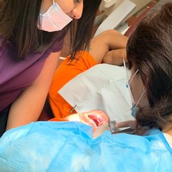 A to Z Dental - Dr. Zhang performs fillings for a patient with help of dental assistant Ana.