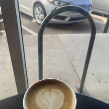 Cartel Roasting Co - My oat latte. Notice the grasshopper in the background. - Cafes Near Me - Tucson, Arizona Cartel Roasting Co - My oat latte. Notice the grasshopper in the background. - Cafes Near Me - Tucson, Arizona