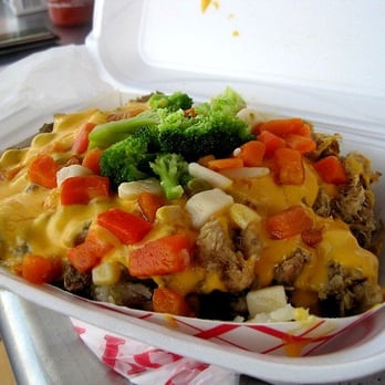 Papas Gourmet - Can't even see the baked potato under the ingredients! Queso, garlic butter, marinated steak, roast pork and mixed veggies. - Latin American Near Me - Orlando, Florida