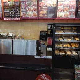  the counter and menus of a dunkin donuts shop