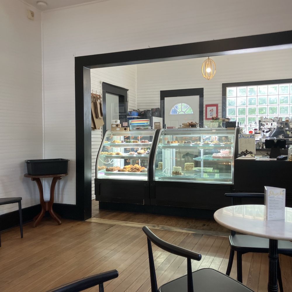 Pastry Case with French pastry and coffee and tea bar.
