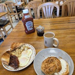 Full Moon Cafe - My breakfast: an onion bagel with cream cheese,  and two fried eggs over easy with bacon, and home fries, with a cup of coffee.