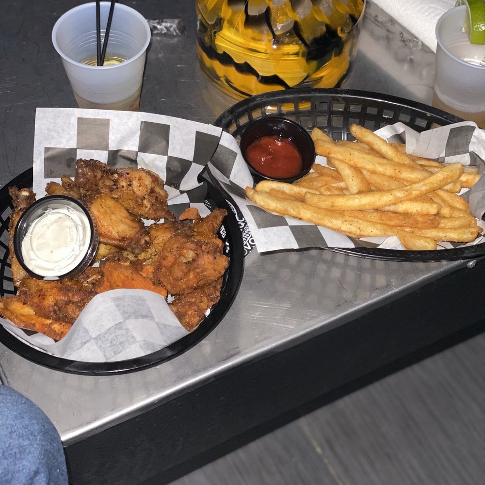 Vossi Bar & Lounge - a tray of chicken wings and french fries - Lounges Near Me - Charlotte, North Carolina Vossi Bar & Lounge - a tray of chicken wings and french fries - Lounges Near Me - Charlotte, North Carolina