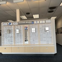 America's Best Contacts & Eyeglasses - High end glasses they offer. Prices range all over the place on this wall.