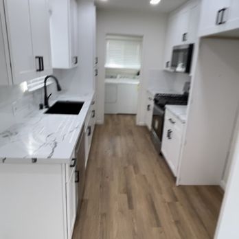 J’s General Contracting - Kitchen renovation with new shaker cabinets, quarts countertops new flooring and new electrical lights tile backsplash - General Contractors Near Me