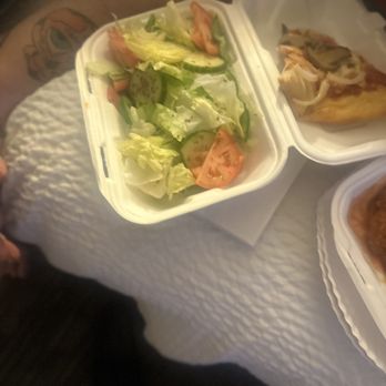 Sinbad Restaurant - a person sitting at a table with food - Pizza Near Me - Ocean City, Maryland