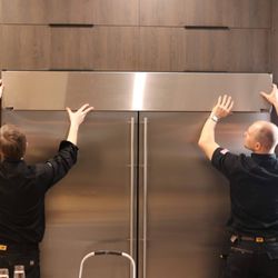 Team work on the big job with the build-in refrigerator repair