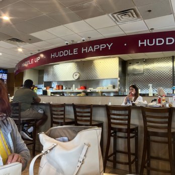Huddle House - a woman sitting at a table - American Near Me - Eagle Pass, Texas