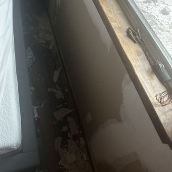 JPM Services - Huge piles on unprotected floor - Interior wall under construction with a window, a wooden windowsill, and construction tools like scissors and wires on the windowsill. - Painters Near Me