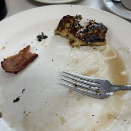 What's left of a French toast and bacon breakfast