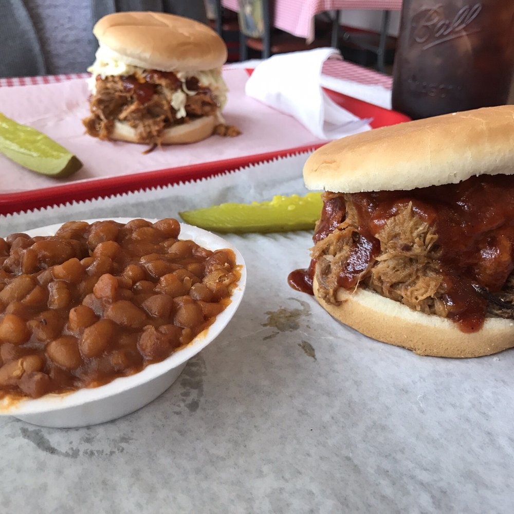 Pulled pork sandwich, one is "topped" (with coleslaw), baked beans, and a pickle. Sweet tea in a mason jar seals the deal. Delicious! Pulled pork sandwich, one is "topped" (with coleslaw), baked beans, and a pickle. Sweet tea in a mason jar seals the deal. Delicious!