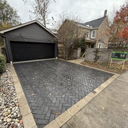 Scott & Sons Landscape Construction - A newly installed interlock driveway boasts a visually appealing herringbone pattern.