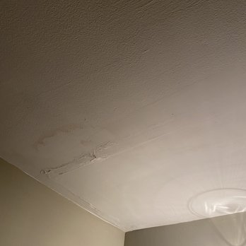 Sandpiper Rentals - Ceiling shows signs of water damage and peeling paint near the corner, with a light fixture visible in the lower right corner. - Vacation Rentals Near Me - Edgartown, Massachusetts