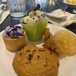 (From left, clockwise) Mini Lemon blueberry tart, mini red velvet cupcake, apple crisp, and chocolate chip cookie.