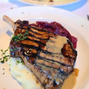 Mustards Grill - The Famous Mongolian Pork Chop with pickled cabbage over a bed of mashed potato - New American Near Me - Napa, California