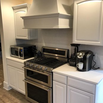 HIS Builders - a kitchen with white cabinets and stainless steel appliances - General Contractors Near Me - South Bend, Indiana